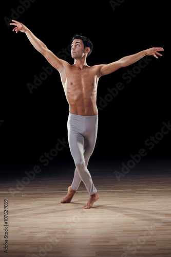 handsome classical dancer on black background