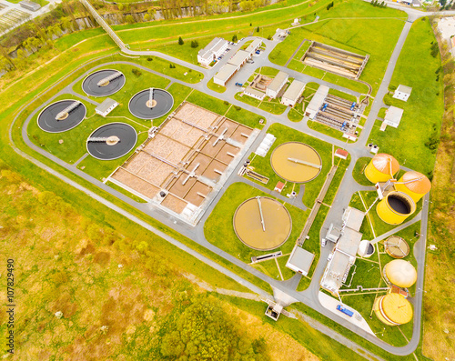 Aerial view to biogas plant from sewage treatment in green fields. Renewable energy from biomass. Waste management for 165, 000 inhabitants of Pilsen city in Czech Republic, Europe. 