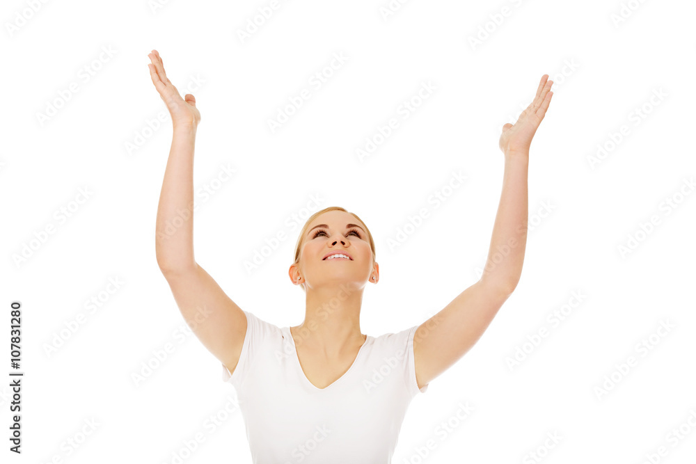 Young woman with outstretched arms looking up Young woman with outstretched arms looking up