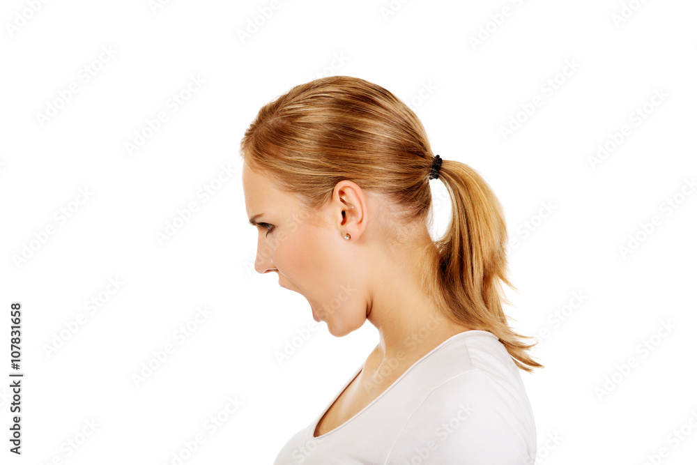 Angry young woman screaming for someone Angry young woman screaming for someone