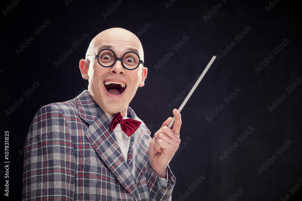 bald caucasian professor or teacher with bow and glasses tie point stick on blackboard with copy space bald caucasian professor or teacher with bow and glasses tie point stick on blackboard with copy space