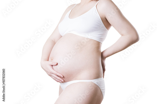 Caucasian pregnant woman in white lingerie with abdominal pain isolated on white background