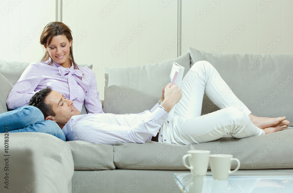 Obraz premium young happy couple relax on couch at home