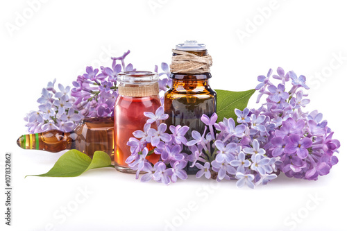 Organic essential aroma oil with lilac on white background