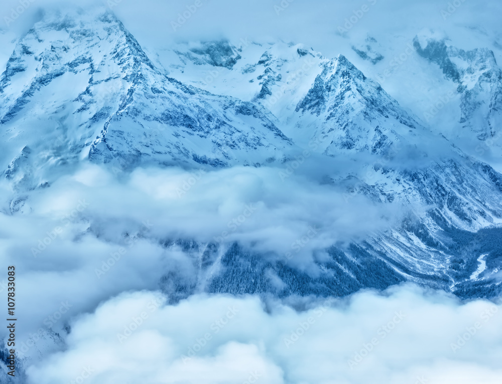 majestic winter landscape of Dombaj mountains covered peaks with clouds majestic winter landscape of Dombaj mountains covered peaks with clouds
