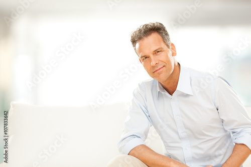 handsome businessman smile on the couch at home