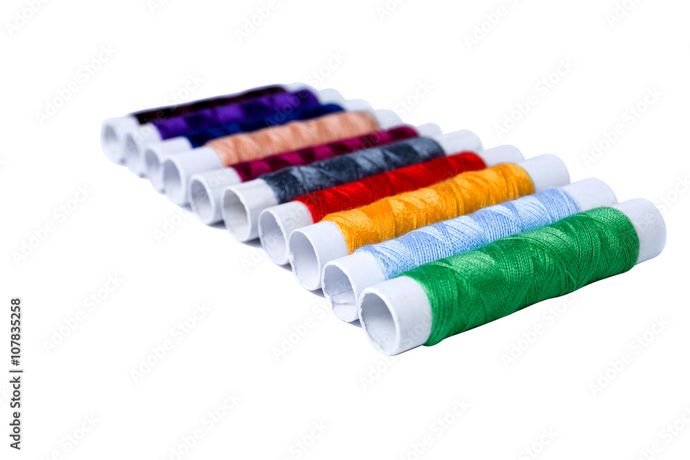 Many-coloured bobbins of thread isolated on white Many-coloured bobbins of thread isolated on white