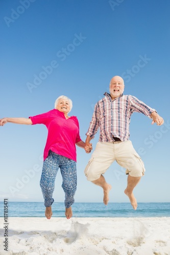 Happy senior couple jumping 