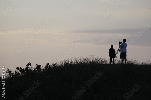 silhouette with man and boy for take a photo