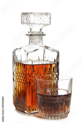 Glass jars with whiskey and ice on white background