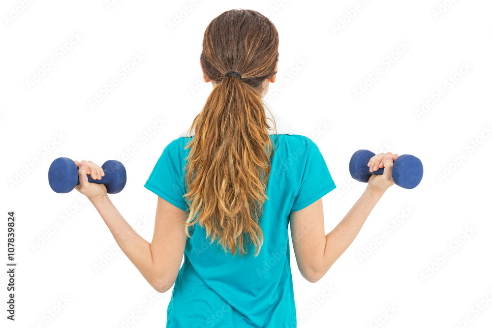 Rearview of woman while lifting weights Rearview of woman while lifting weights