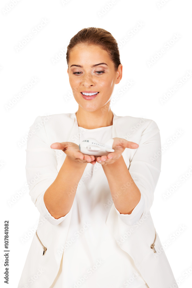 Beautiful businesswoman holding airplane model Beautiful businesswoman holding airplane model