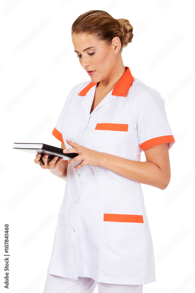 Young female doctor or nurse holding black notes Young female doctor or nurse holding black notes