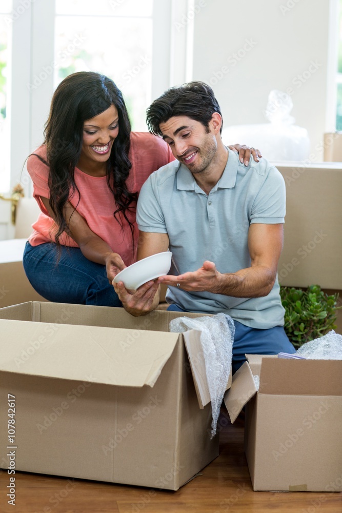 Young couple unpacking carton boxes in their new house Young couple unpacking carton boxes in their new house