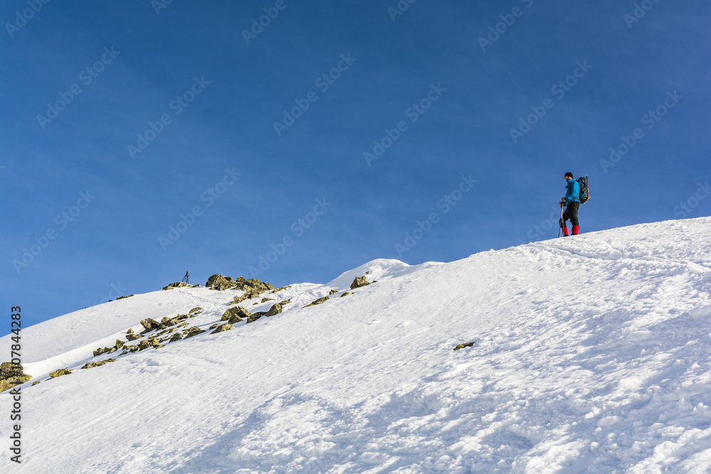 Tourist on a snowy ridge.