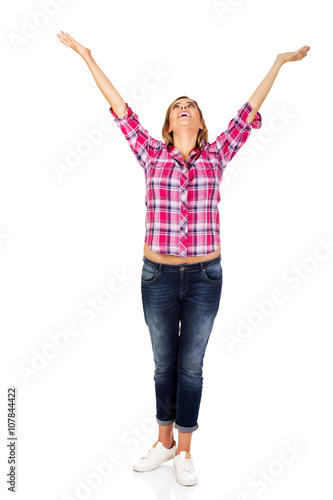 Happy blonde woman standing with hands up 