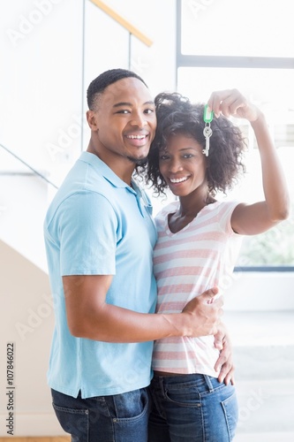 Young couple showing their house key