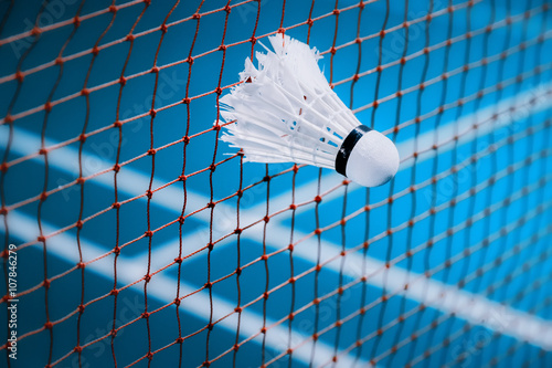 shuttlecocks struck on the net in badminton court for sport background © exzozis