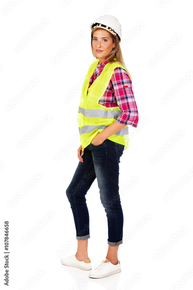 Fototapeta premium Young smile female builder in vest