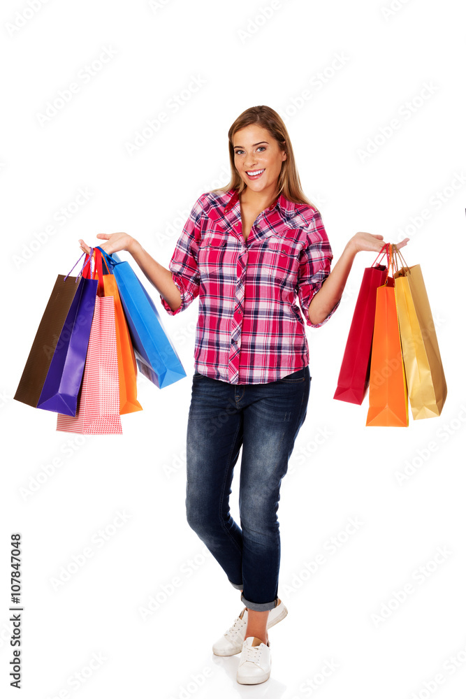 Young smiling woman holding shopping bags