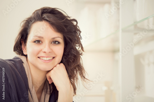 young smiling brunette woman in the kitchen