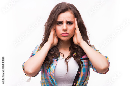 Young woman holding her head.Migraine and headache problem.Overworked,stressed woman.Menstrual and period pain.Intensive lifestyle and fast life.