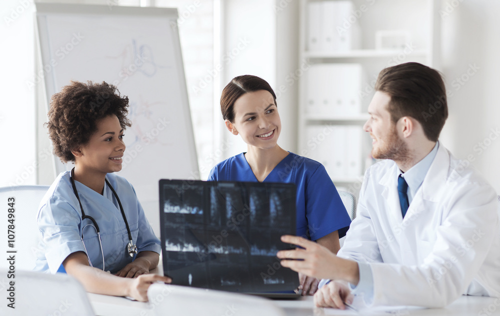 group of happy doctors discussing x-ray image group of happy doctors discussing x-ray image
