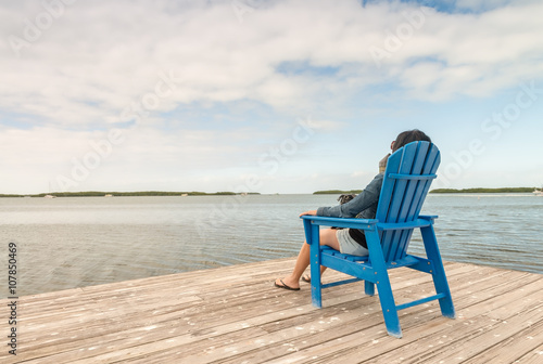 Woman relaxing seated near the ocean