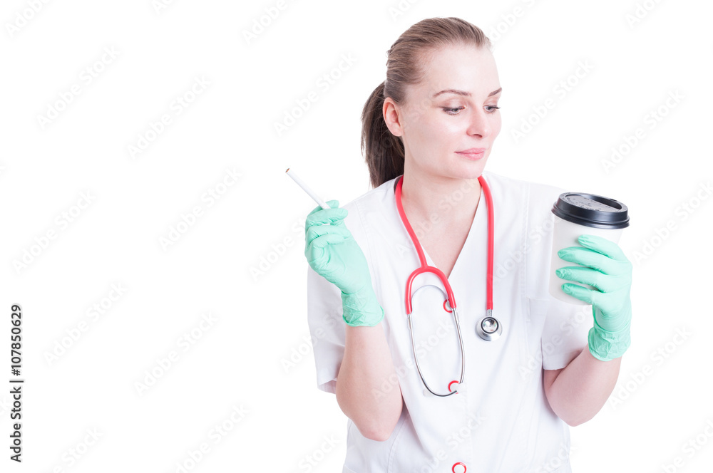 Attractive female doctor smoking and drinking coffee on her brea Attractive female doctor smoking and drinking coffee on her brea