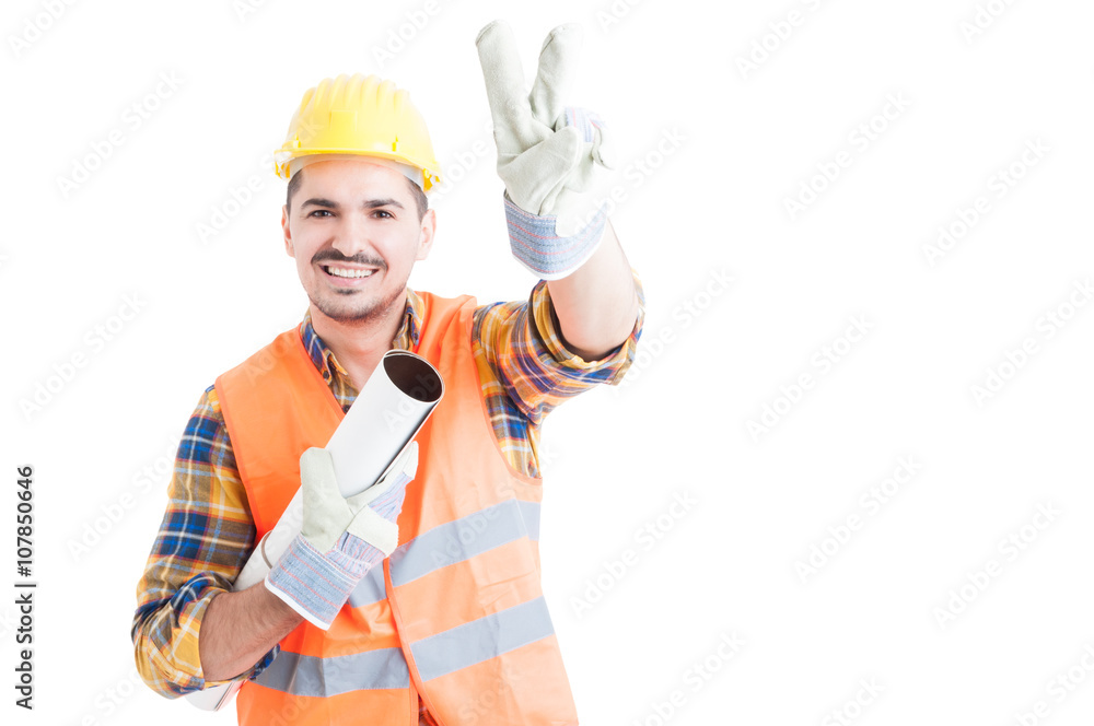 Portrait of cheerful young engineer making peace or victory gest Portrait of cheerful young engineer making peace or victory gest