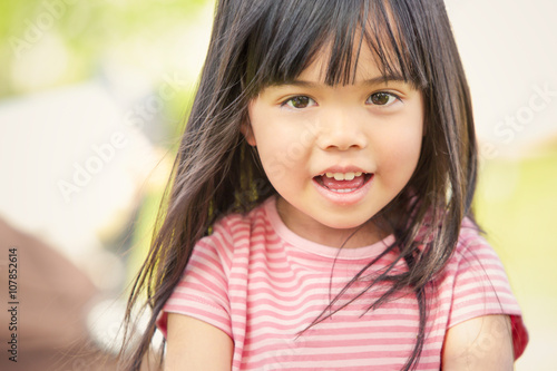 happy asian smiling child play in a garden