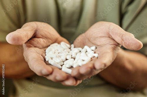 Hand is holding and showing some medicine pills