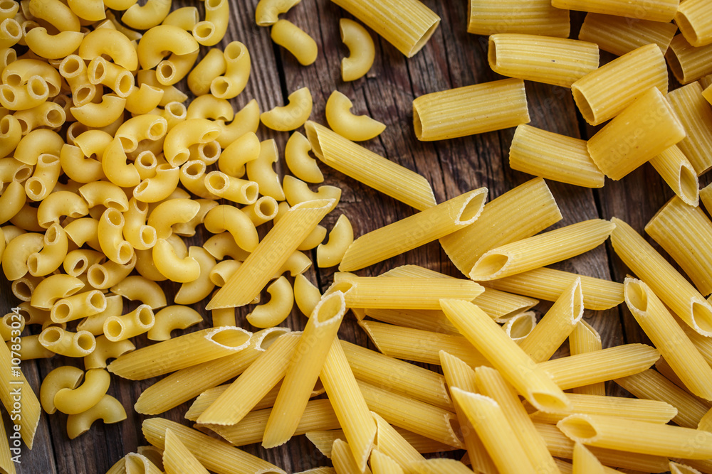 close up portrait of raw homemade italian pasta, macaroni, spaghetti, and fettuccine close up portrait of raw homemade italian pasta, macaroni, spaghetti, and fettuccine