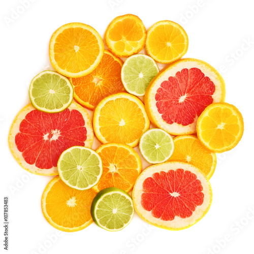 Surface covered with citrus sliced fruits over white isolated background