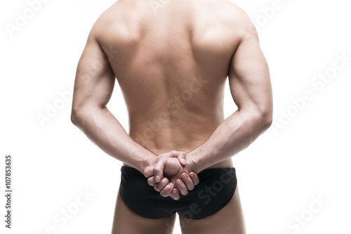 Handsome muscular bodybuilder posing on white background. Isolated studio shot