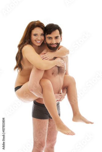 Man carrying girlfriend on his back.