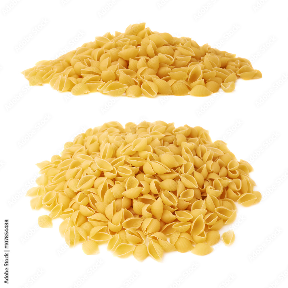 Pile of dry conchiglie pasta over isolated white background Pile of dry conchiglie pasta over isolated white background