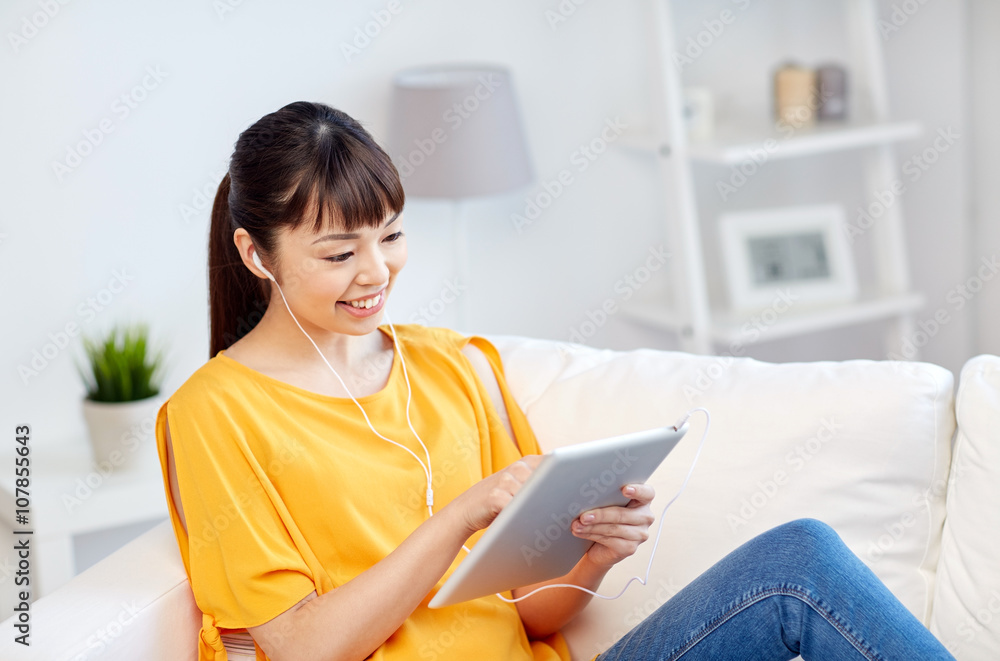happy asian woman with tablet pc and earphones happy asian woman with tablet pc and earphones