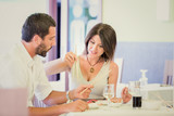 Young couple  using chopsticks at restaurant