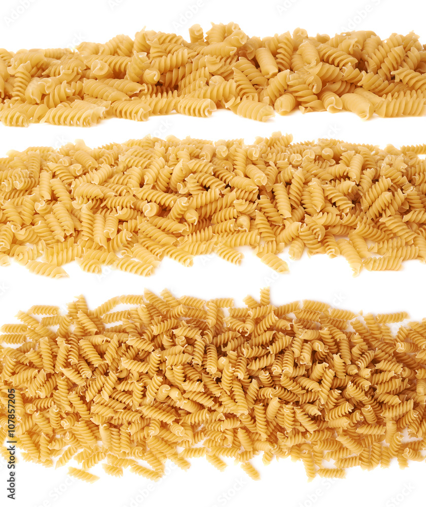 Line made of dry rotini pasta over isolated white background Line made of dry rotini pasta over isolated white background