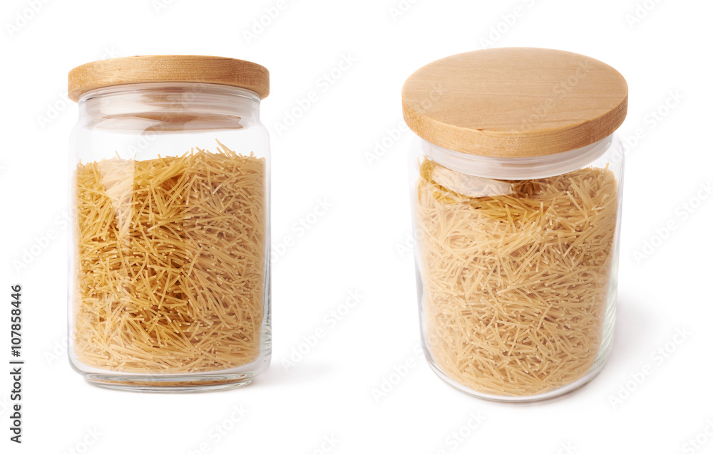 Set of glass jar filled with dry noodles pasta over isolated white background Set of glass jar filled with dry noodles pasta over isolated white background