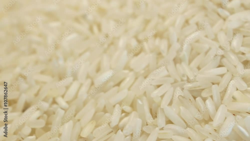 4k Raw rice rotating smoothly under studio lighting, looped video 4k Raw rice rotating smoothly under studio lighting, looped video