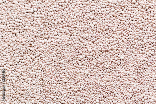 Pink background with mineral fertilizers balls.