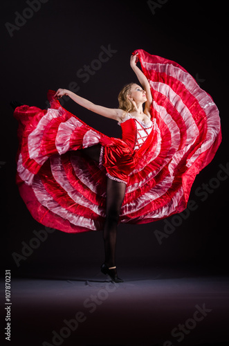 Young woman dancing in red dress