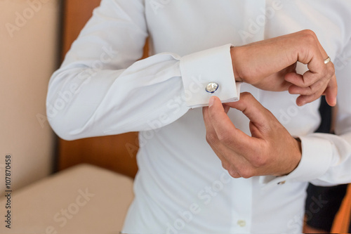 man wear cufflink on white shirt