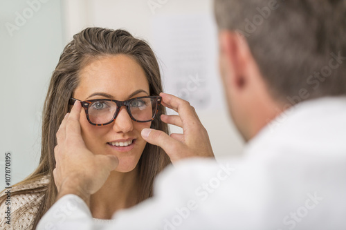 Woman choosing her new glasses