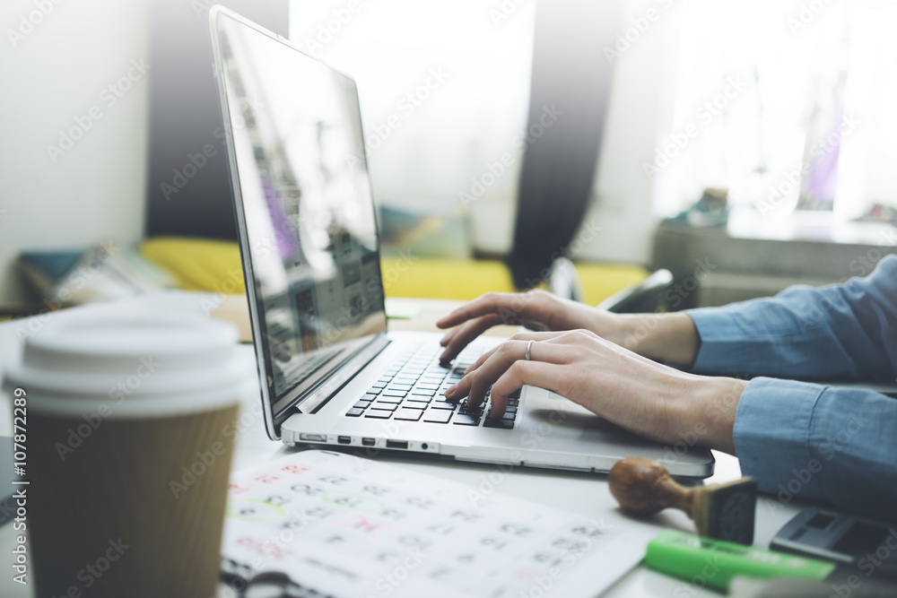 Closeup of female hands using modern laptop in interior, businesswoman working at her office on technology Closeup of female hands using modern laptop in interior, businesswoman working at her office on technology