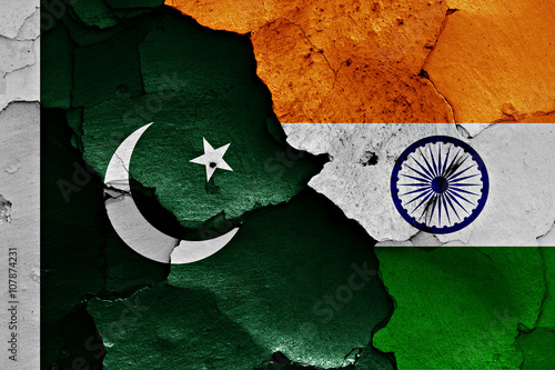 flags of Pakistan and India painted on cracked wall