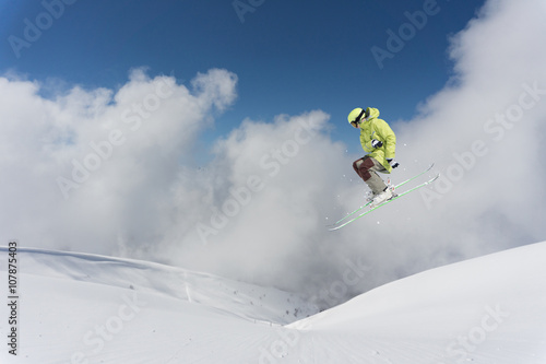 Ski rider jumping on mountains. Extreme ski freeride.