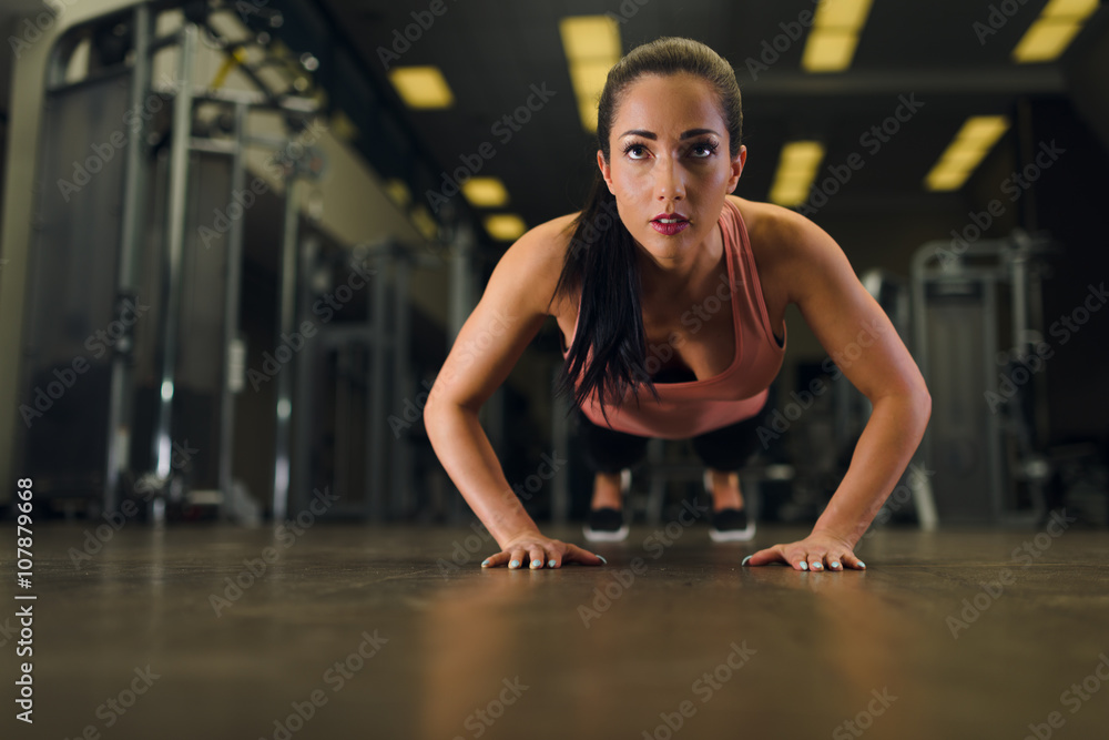 Attractive young female working out at the gym